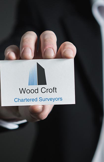 A businessman hold a Wood Croft business card.